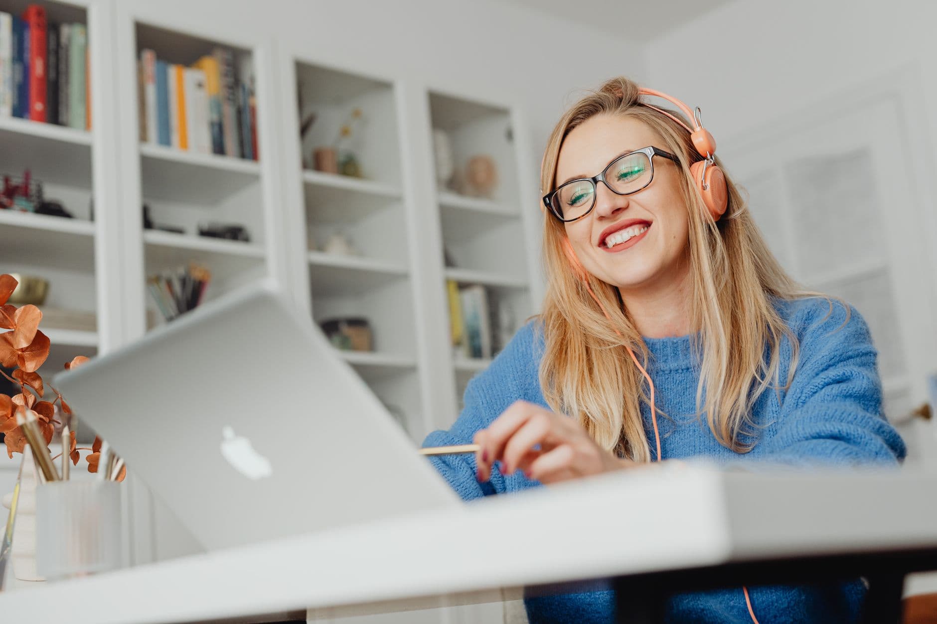 A pleased customer smiling at what is on their laptop